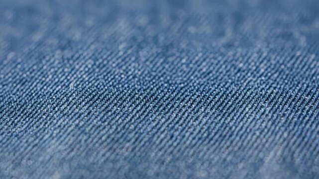 A closeup shot showcasing the intricate texture and pattern of blue denim fabric, creating a visually appealing textile surface