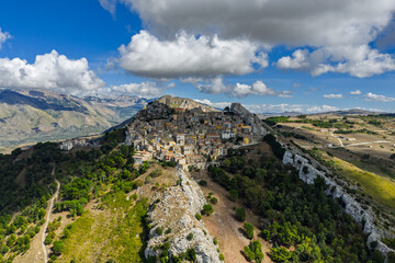 Aerial drone view of Sclafani Bagni, a small historic Sicilian mountain town perched on cliffs with panoramic views of Caltavuturo and rugged Madonie Mountains, Sicily, Italy.Small Village in Sicily