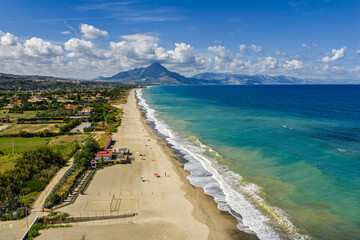  Aerial drone view of Lascari Beach, a scenic coastal area near the Madonie Mountains in northern Sicily, Italy, golden sand, turquoise Tyrrhenian Sea waters, and a peaceful Mediterranean landscape