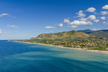  Aerial drone view of Lascari Beach, a scenic coastal area near the Madonie Mountains in northern Sicily, Italy, golden sand, turquoise Tyrrhenian Sea waters, and a peaceful Mediterranean landscape