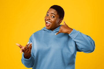 Call Me Gesture. Cheerful Oversized African American Lady Holding Hand Like Cellphone Near Ear...