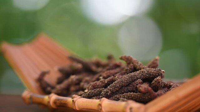 Dried piper longum fruits on natural background.