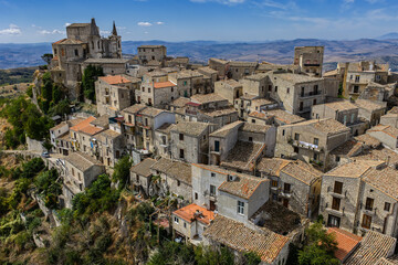 Fototapeta premium Aerial drone view of Petralia Soprana, a historic Sicilian mountain town with panoramic views of the Madonie Mountains,Petralia Soprana famous Church of Saint Mary of Loreto, Sicily, Italy