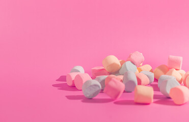 colorful marshmallows on pink background © Maynor