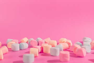 colorful marshmallows on pink background © Maynor