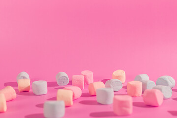 colorful marshmallows on pink background © Maynor