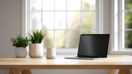 Fototapeta premium Minimalist Indoor Workspace with Wooden Desk, Laptop, and Green Plants in Natural Light Setting