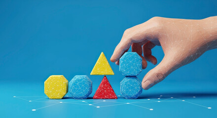 Hand arranging colorful geometric shapes on blue background.