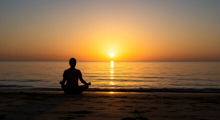 Fototapeta premium Silhouette of a Person Meditating by the Beach During Vibrant Sunset Over Calm Ocean