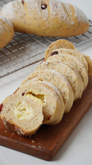 Cranberry cream cheese bread that has been cut into small pieces placed on wood plate isolated on a white background