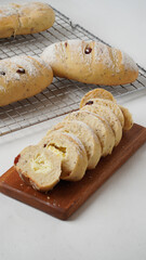 Cranberry cream cheese bread that has been cut into small pieces placed on wood plate isolated on a white background