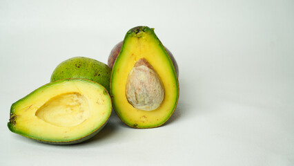 A slice of fresh buttery avocado isolated on a white background