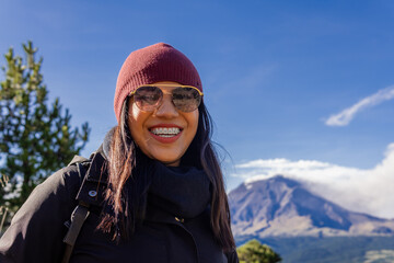 Smiling woman hiking iztaccihuatl mountain with popocatepetl volcano