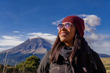 Woman hiking in mountains with popocatepetl volcano background