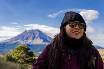 Woman hiking iztaccihuatl volcano with popocatepetl in background mexico
