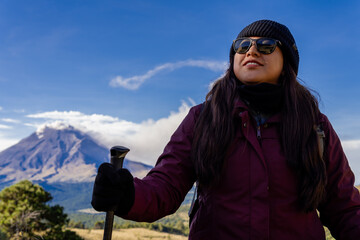 Woman hiking iztaccihuatl volcano with popocatepetl in background