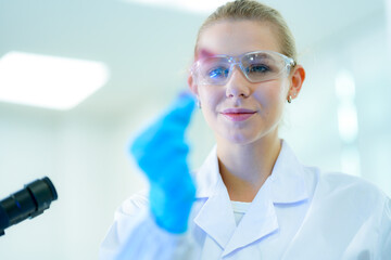 A biotechnologist observes the positive result of a fluorescence assay, where the glowing reagent...
