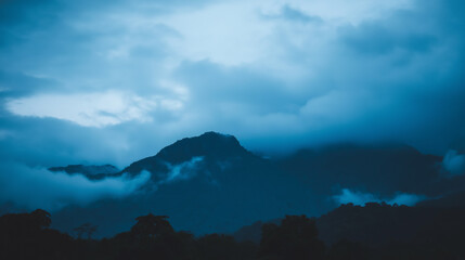 A majestic mountain silhouette against a twilight sky, radiating calm and natural beauty.