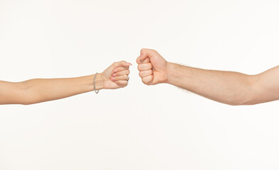 male and female hands clenched into fists opposite each other