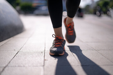 Woman running in urban setting achieving fitness goals