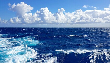 Fototapeta premium Vast expanse of the deep blue ocean under a cloudy sky.