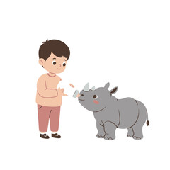 A child feeding a baby rhinoceros with a bottle, showcasing a tender interaction.