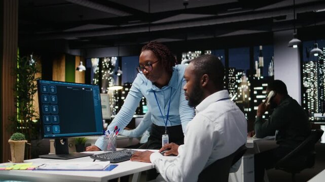 African american staff members use AI chatbot system at pc for problem solving tasks, futuristic high tech highlighting smart algorithms and deep learning. Communication and IT support. Camera A.