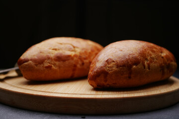 Freshly baked bread rolls on a wooden board
