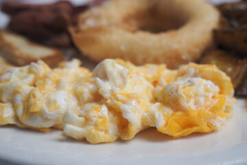 Breakfast spread with scrambled eggs and side items