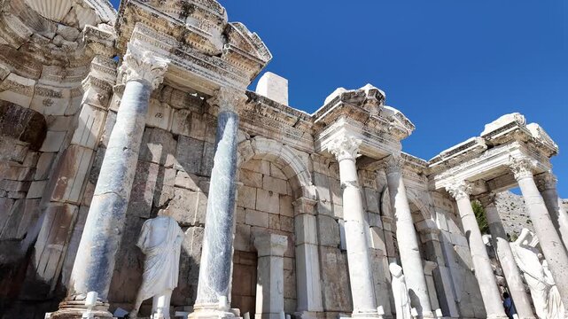 Burdur, Turkey: Tilt down footage of a statue at the Antonine Nymphaeum, a fountain located in the upper agora of Sagalassos archeological site in Turkey during sunny day