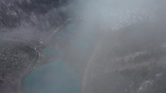 Drone view of Jiuzhaigou National Park in spring in Sichuan Province China. It features cascading waterfalls, turquoise blue lakes, and stunning mountain valleys. 4K real time footage travel concept.