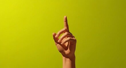 A person's hand with the index finger pointing straight up against a solid lime green background.