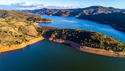 National reservoir or dam in the middle of the valley and the road connecting the city at chiang rai thailand high angle view from drone camera
3