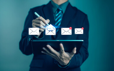 Businessman using digital tablet for email communication and online marketing. Concept of business networking, e-commerce, digital message, and professional connection in modern technology.