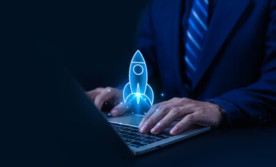Businessman using laptop with rocket icon symbolizing startup launch, innovation, technology growth, and digital success. Concept of business development, entrepreneurship, and online progress.