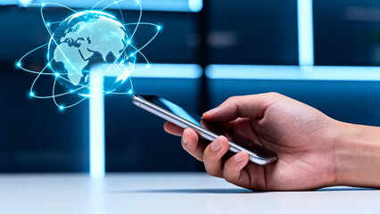 Hand holding smartphone with digital globe