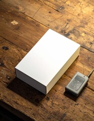 Fototapeta premium Blank White Box on a Weathered Wooden Table, Accompanied by a Remote Control
