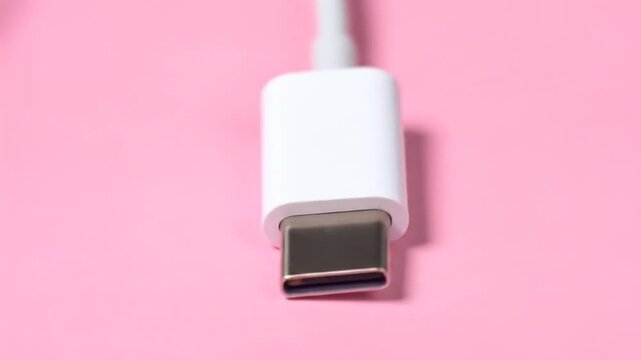 USBC cable connector on pink background.