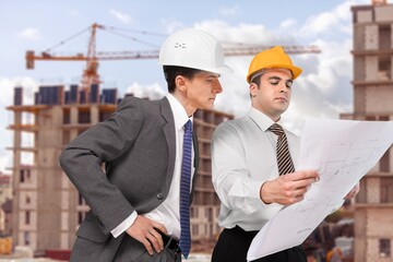 Civil engineer and architect discuss at construction site