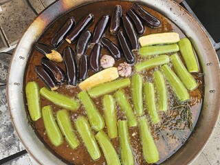 Eggplant and zucchini are fried with garlic and herbs in oil