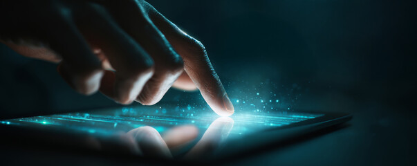 Finger touching tablet screen glowing with blue light and digital particles, close up fingertip interaction conveying futuristic technology