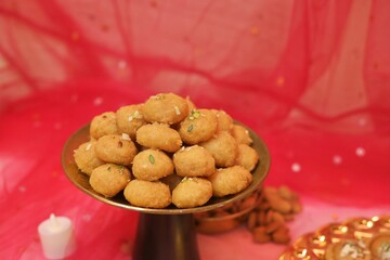Balushahi or makkhan bada beautifully decorated with a festive celebration background 