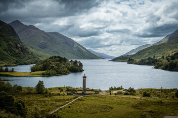 Fototapeta premium Scenic View of Glenfinnan Monument and Loch Shiel under Cloudy Sky in the Scottish Highlands - Scotland