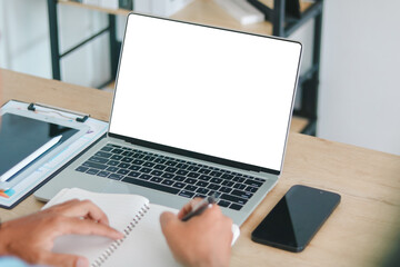 Workspace with laptop blank screen, smartphone, tablet, and notebook. Concept of remote work,...