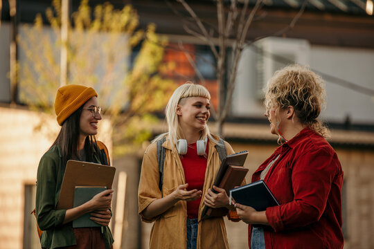 Students talking and smiling on university campus