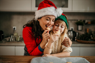 Mother and daughter enjoying christmas baking and cookies