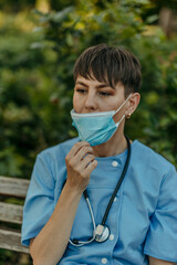 Healthcare worker taking a break removing mask