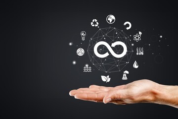 Businessman holding a sustainability icon, corporate responsibility