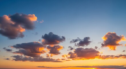 Fototapeta premium Stunning sunset sky with dramatic clouds in vibrant hues. The backlit clouds create a breathtaking natural display against the clear blue sky, evoking feelings of tranquility and inspiration.