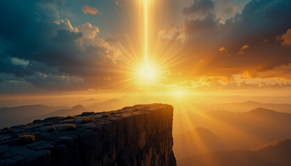 Golden sunset over mountain range with a cliff in the foreground.